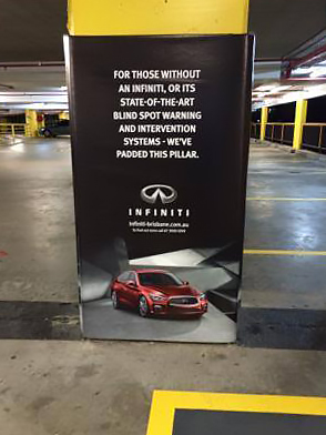 A column in a parking garage with a Cingo Protective Wrap installed that shows an advertisement for Infiniti cars