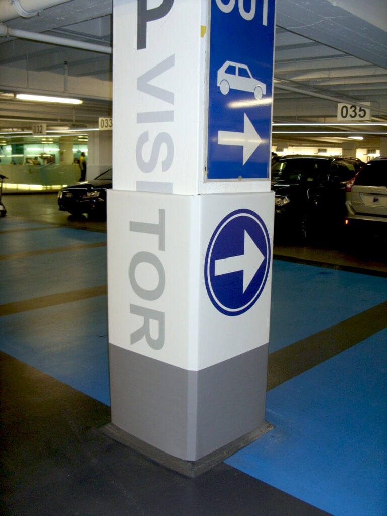 A column in a parking garage with a Cingo Protective Wrap installed that is printed to show visitors where they can and can't park