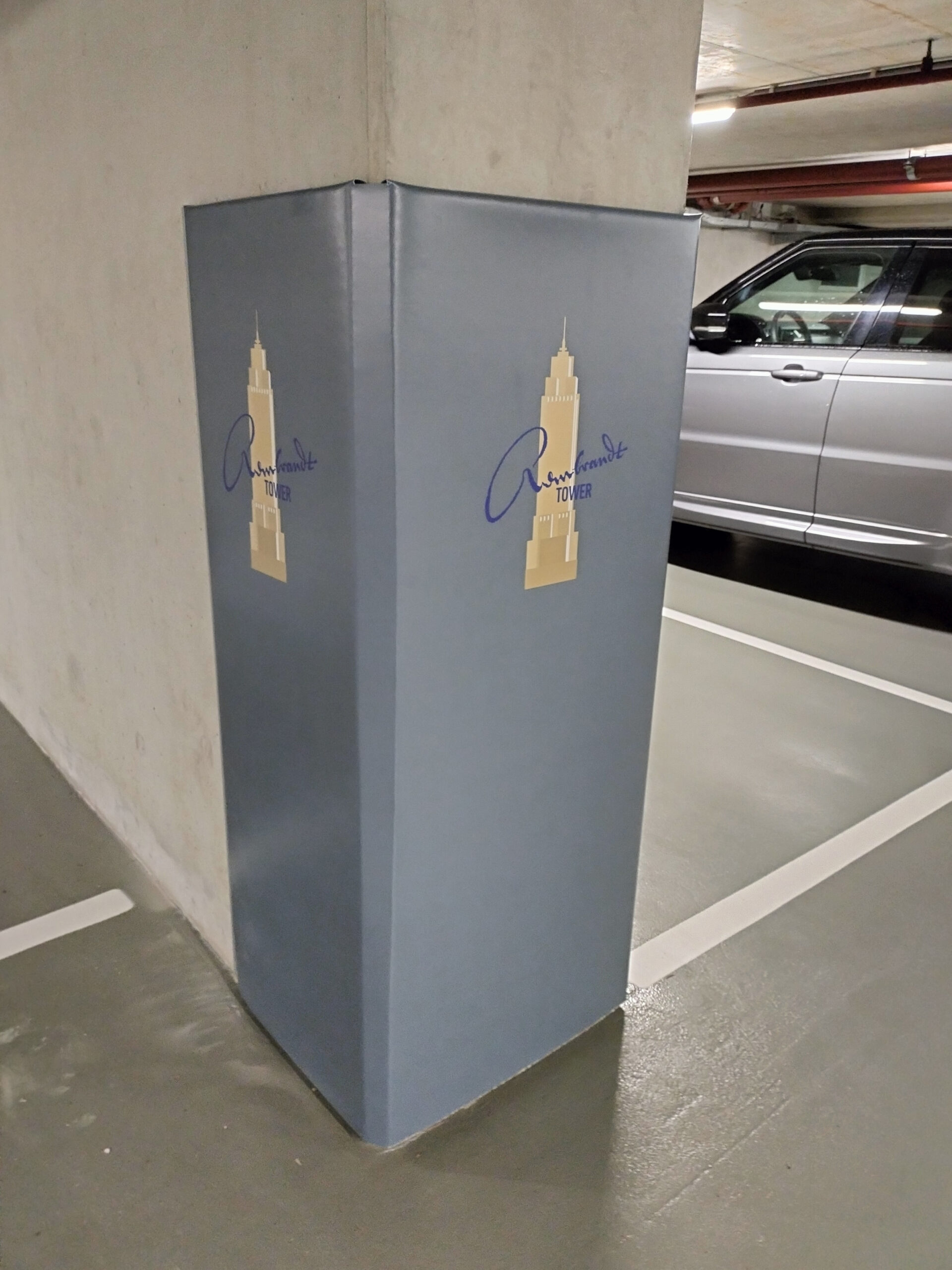 A Cingo Protective Wrap installed on a concrete wall in a parking garage to protect both cars and the wall from damage