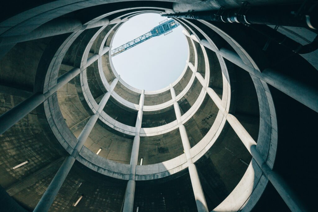 Looking up through a spiraling parking garage at the sky